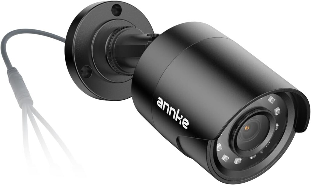 Wall-mounted wired security camera system camera covering garage door and tool storage area
